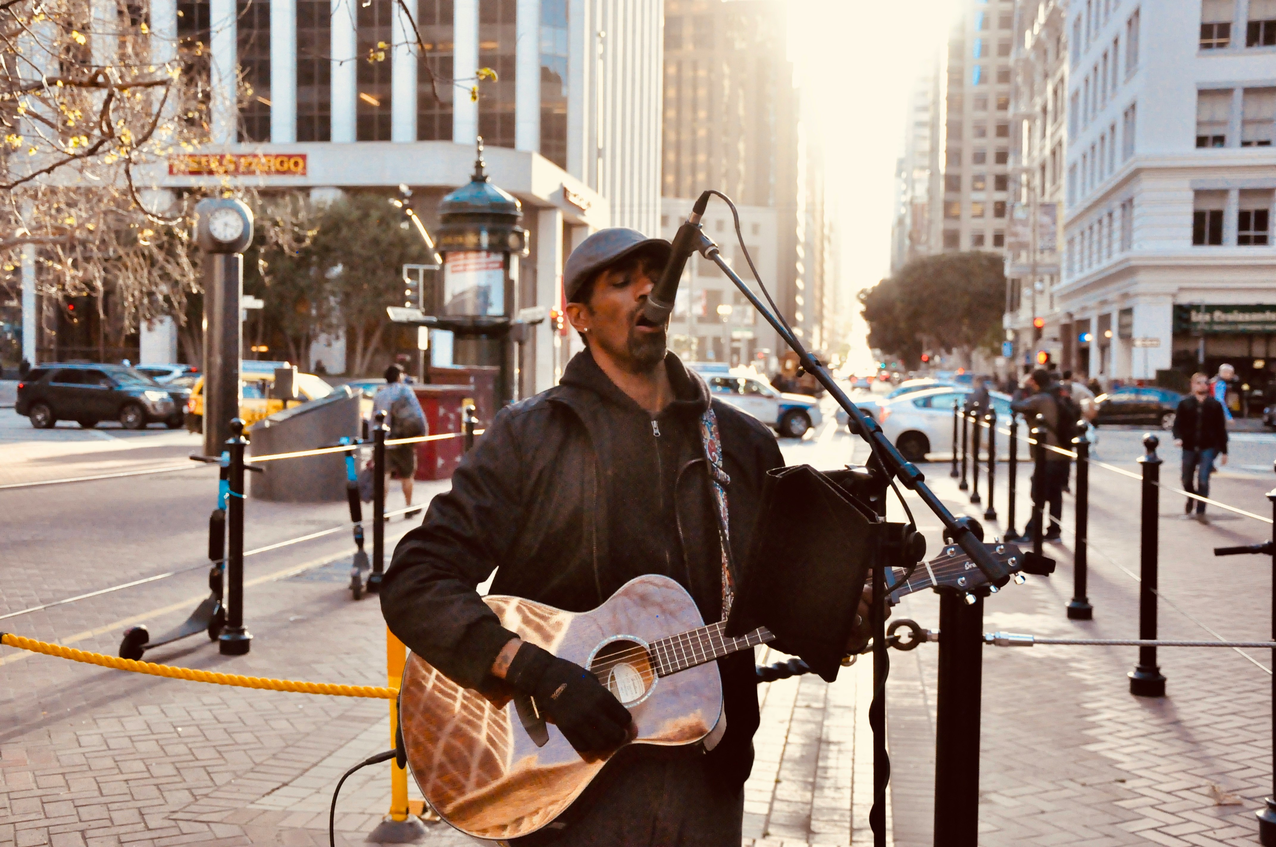 man in black jacket playing guitar